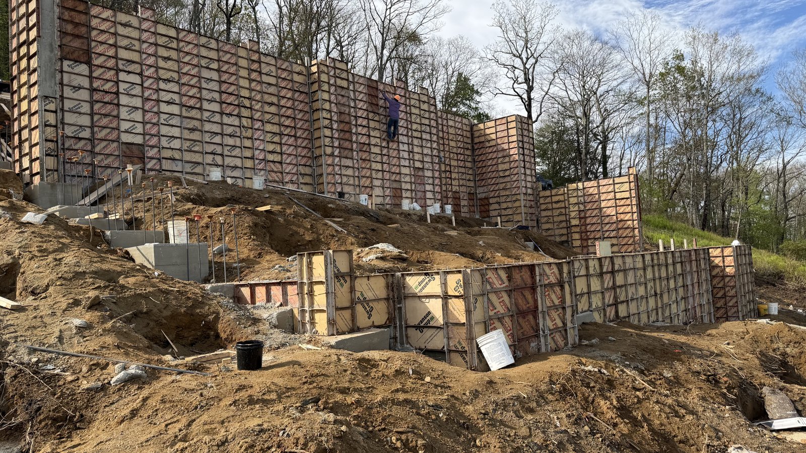 Site preparation in progress on a Highlands-Cashiers Plateau custom home build, showing slope work, retaining, and excavation in mountain terrain