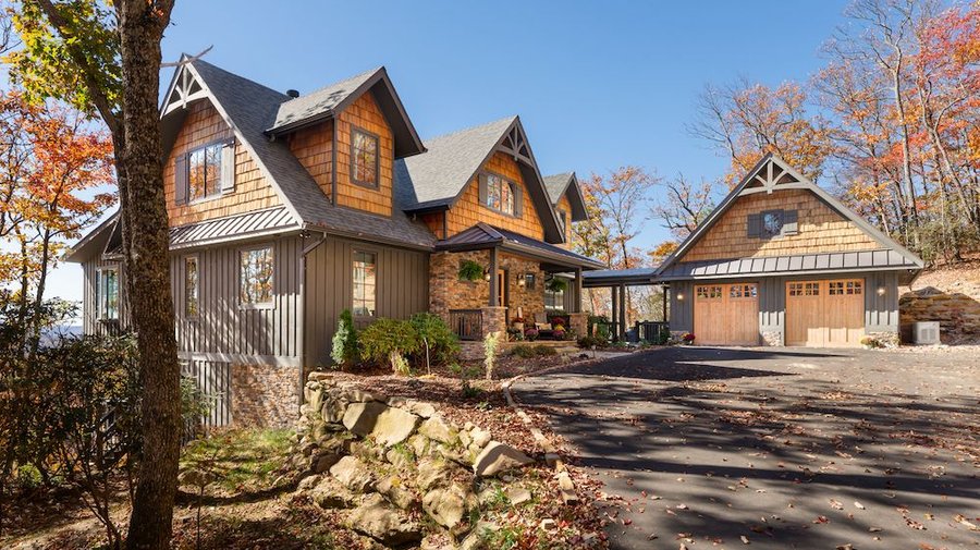 A Powell Construction custom home in the Cashiers area on the Highlands-Cashiers Plateau, cedar shake and stone with mountain terrain